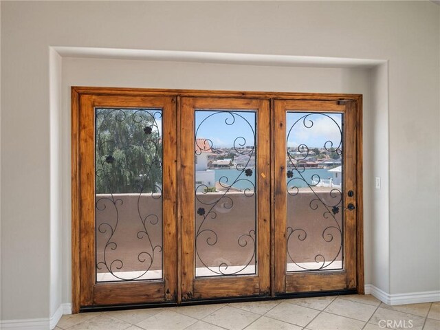 doorway to outside with french doors and light tile patterned floors