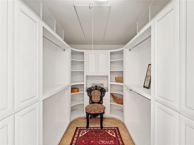 walk in closet with light tile patterned floors