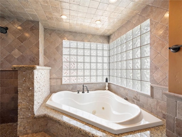 bathroom featuring tiled shower, recessed lighting, and a jetted tub