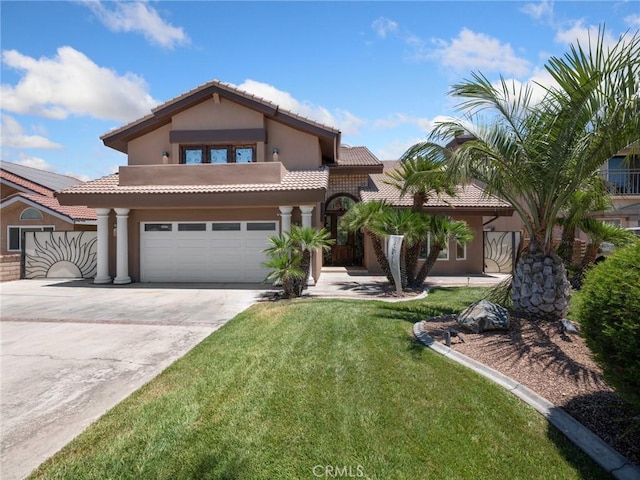 mediterranean / spanish house featuring stucco siding, a tiled roof, concrete driveway, and a front lawn