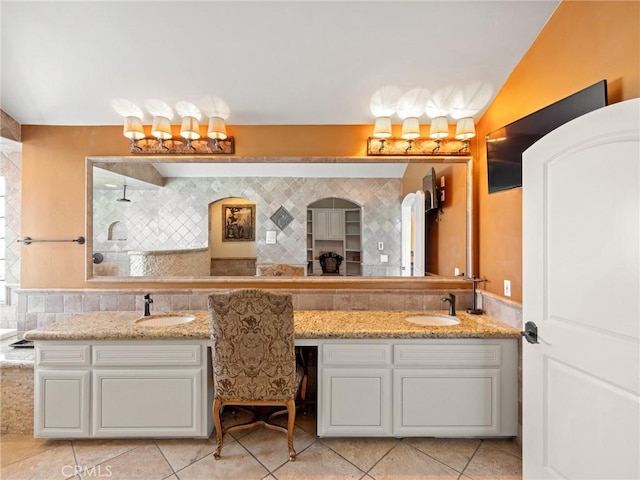 full bathroom with tile patterned floors, tasteful backsplash, walk in shower, and vanity