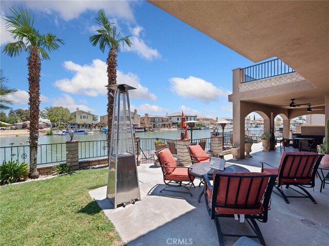 view of patio / terrace featuring ceiling fan and a water view