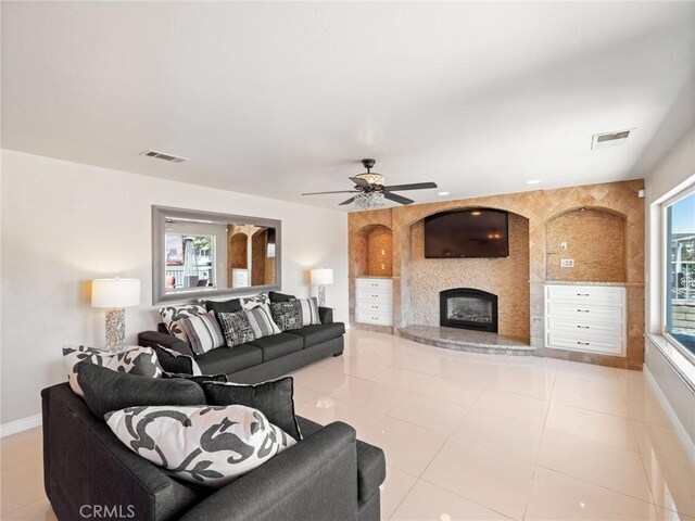 living room featuring ceiling fan and light tile patterned floors