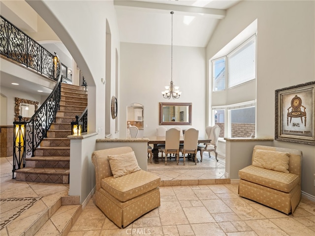 living area with high vaulted ceiling, an inviting chandelier, and beamed ceiling