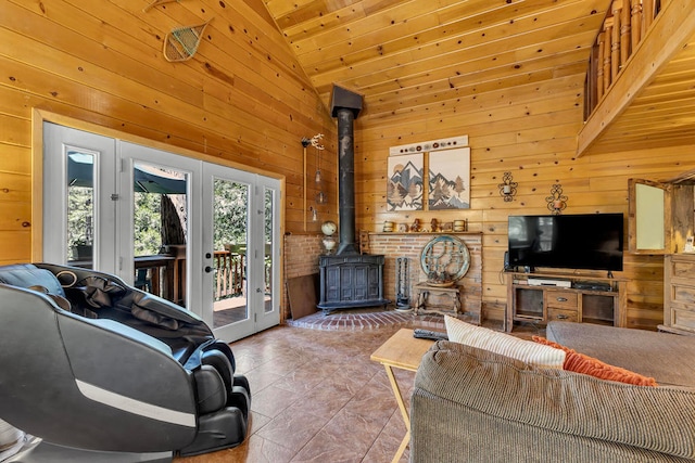 tiled living room featuring wooden ceiling, wooden walls, french doors, high vaulted ceiling, and a wood stove