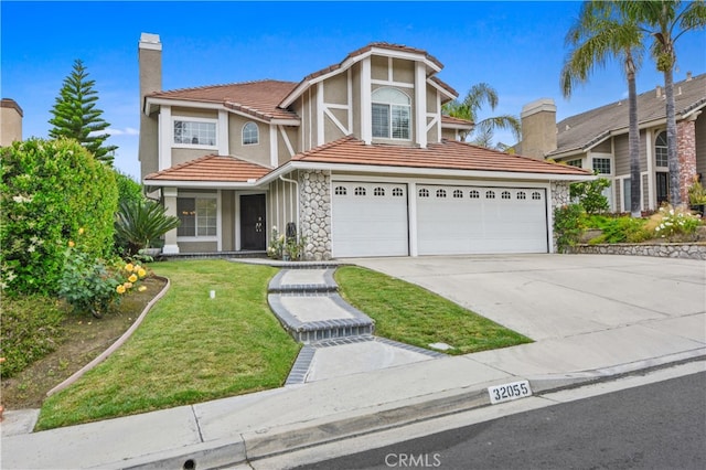 view of front of house with a front lawn and a garage