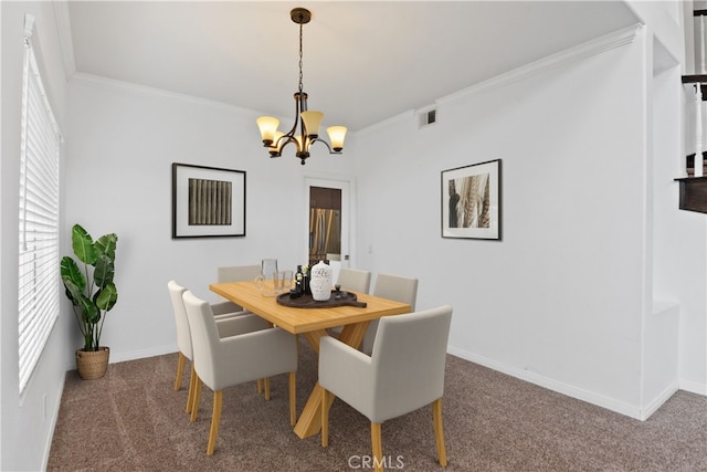 carpeted dining area featuring ornamental molding and a chandelier