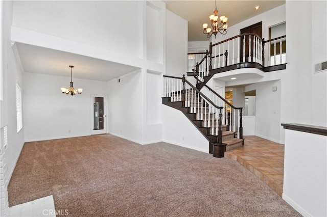 carpeted living room featuring a notable chandelier and a high ceiling