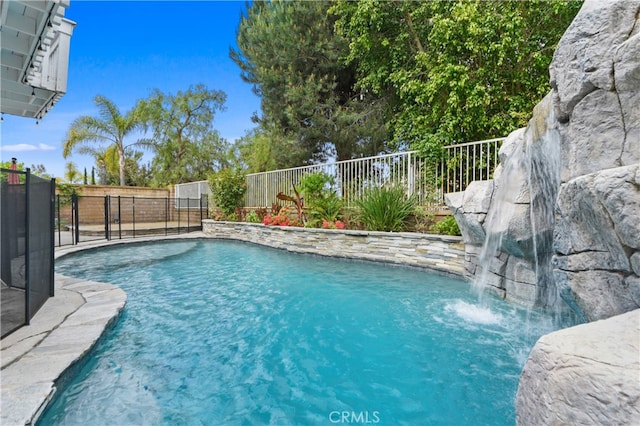 view of swimming pool with pool water feature