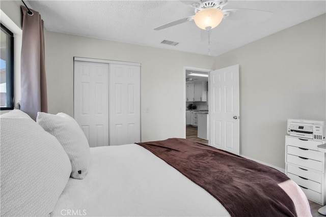 bedroom featuring ceiling fan, a closet, and hardwood / wood-style floors