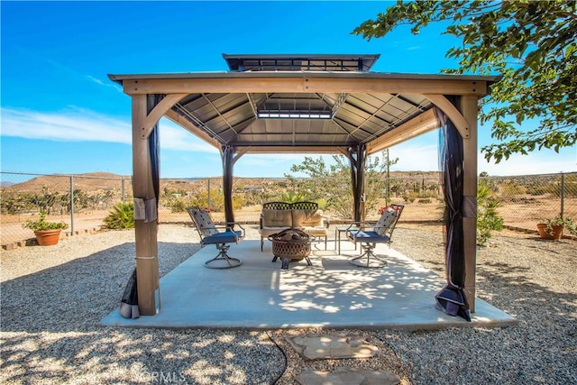 view of patio featuring an outdoor fire pit and a gazebo