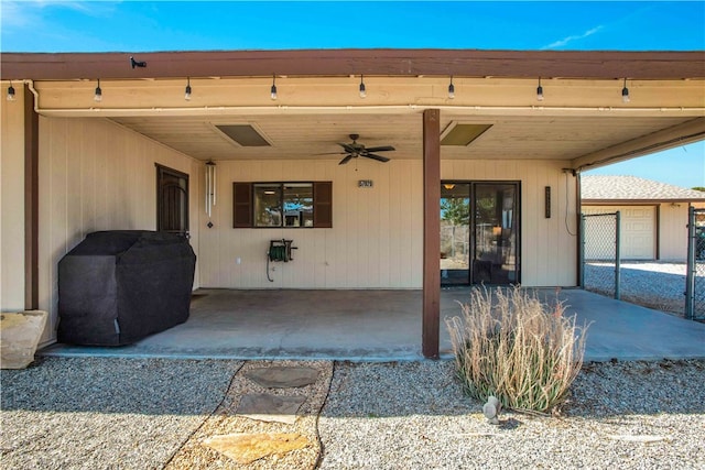 doorway to property featuring ceiling fan and a patio