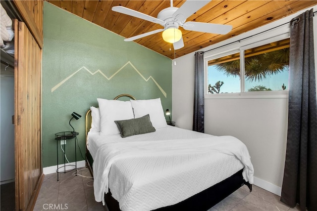 tiled bedroom featuring wooden ceiling, vaulted ceiling, and ceiling fan