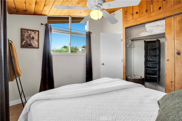 bedroom with ceiling fan, a closet, vaulted ceiling, and wood ceiling