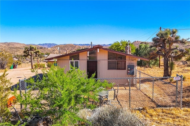 rear view of property featuring a mountain view