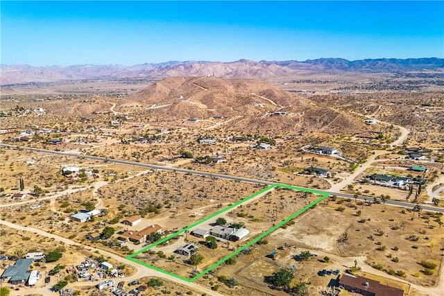 birds eye view of property with a mountain view