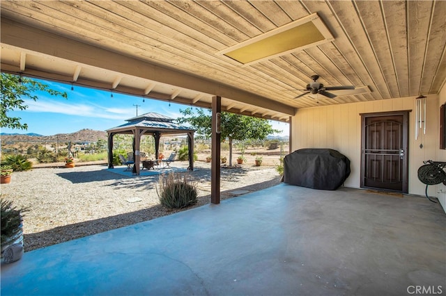 view of patio featuring a mountain view, a gazebo, and area for grilling