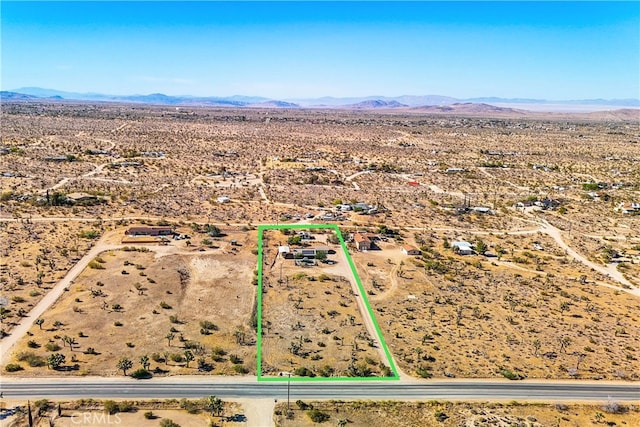 birds eye view of property featuring a mountain view