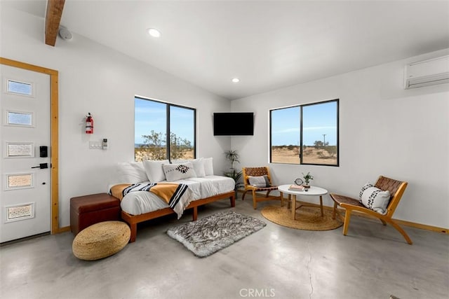 living area with a healthy amount of sunlight, concrete flooring, and a wall mounted AC