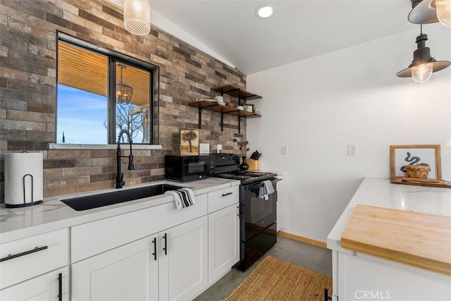 kitchen with black / electric stove, sink, concrete floors, decorative light fixtures, and white cabinetry