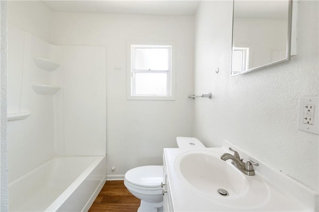 full bathroom featuring wood-type flooring, vanity, toilet, and tub / shower combination