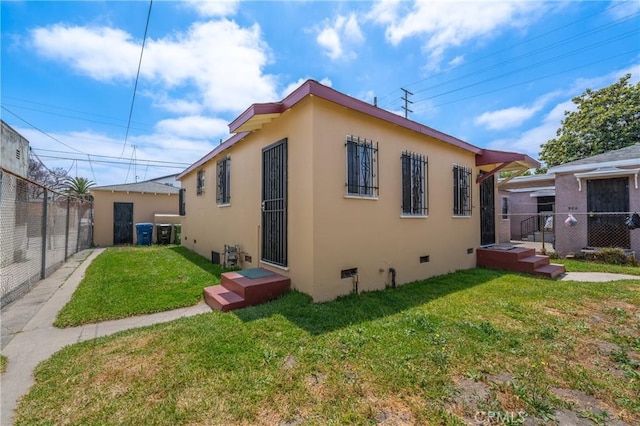 back of house with a lawn