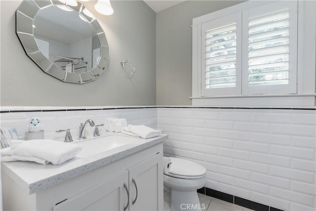 bathroom with tile patterned flooring, vanity, and toilet