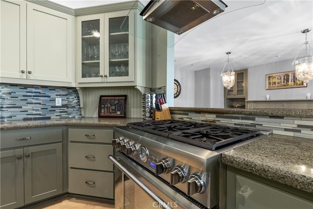 kitchen with decorative light fixtures, stainless steel stove, gray cabinets, and ventilation hood