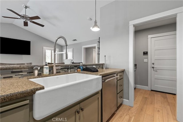 kitchen with vaulted ceiling, sink, pendant lighting, light hardwood / wood-style flooring, and dishwasher