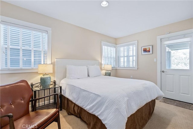 carpeted bedroom featuring multiple windows