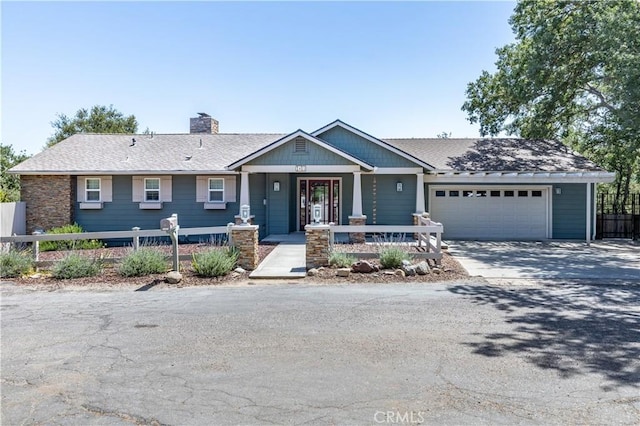 view of front of home featuring covered porch and a garage