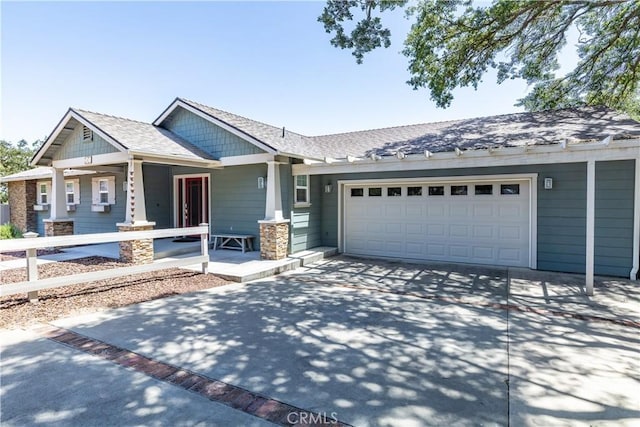 view of front of home featuring a porch and a garage