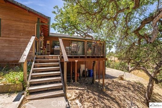 rear view of house featuring a deck