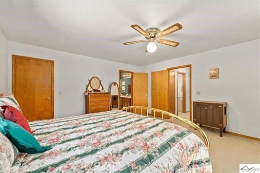 carpeted bedroom featuring ceiling fan