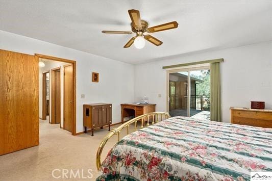 bedroom featuring access to exterior, ceiling fan, and light colored carpet