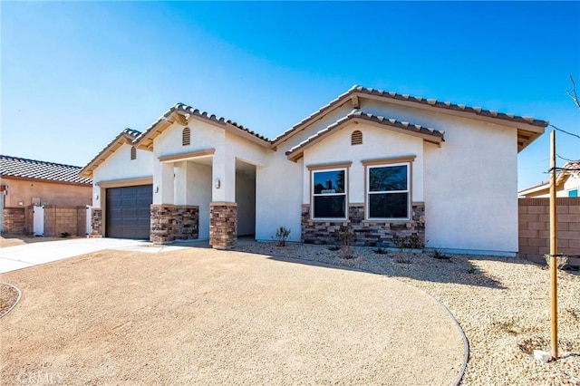 mediterranean / spanish home featuring a garage