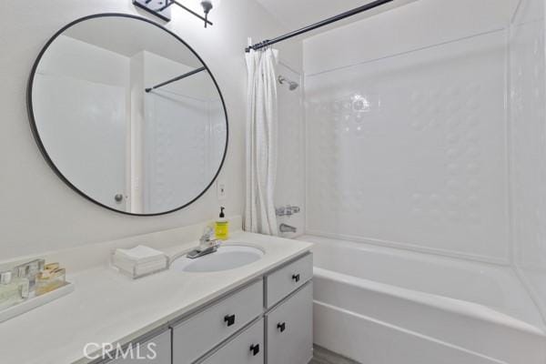 bathroom featuring shower / tub combo and vanity