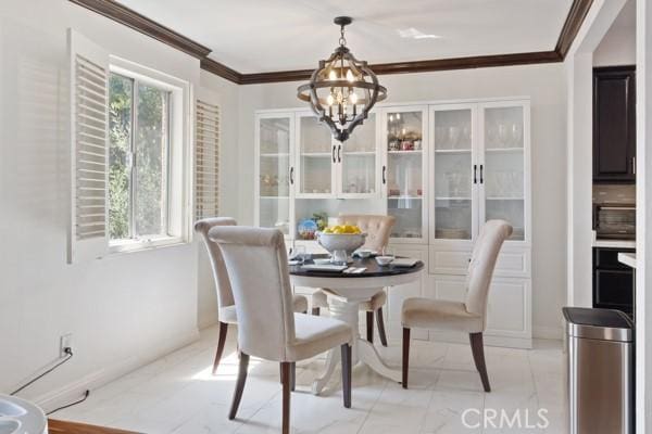 dining room with crown molding and a chandelier