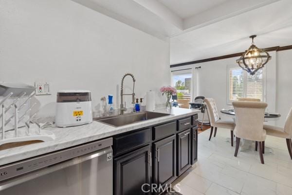 kitchen featuring light stone countertops, stainless steel dishwasher, sink, an inviting chandelier, and hanging light fixtures