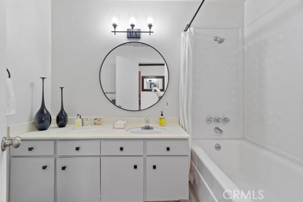 bathroom with shower / tub combo with curtain and vanity