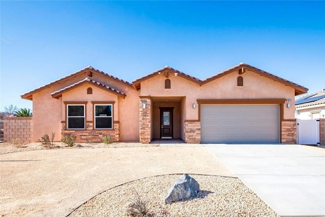 mediterranean / spanish-style home with a garage