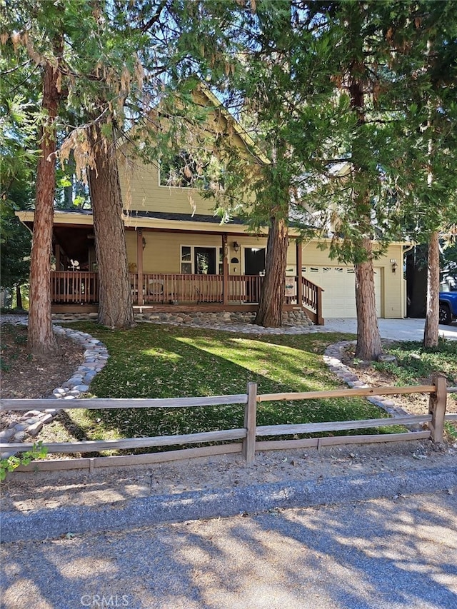 view of front of house with a porch, a garage, and a front lawn