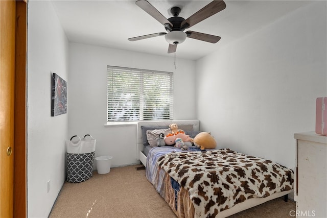 bedroom featuring light colored carpet and ceiling fan