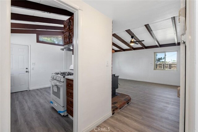 hallway with vaulted ceiling with beams and dark wood-type flooring