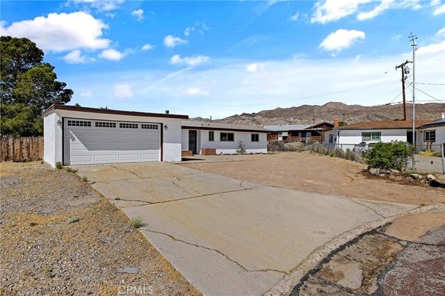 ranch-style home featuring a mountain view and a garage