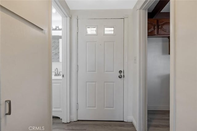 doorway to outside with wood-type flooring