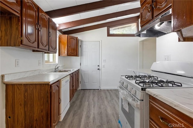 kitchen with white appliances, lofted ceiling with beams, light hardwood / wood-style flooring, and sink