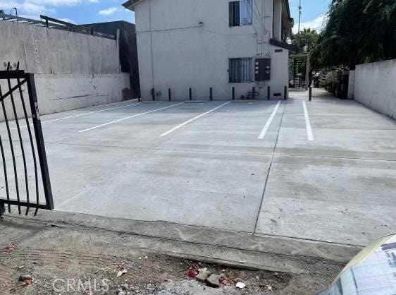 view of parking with fence