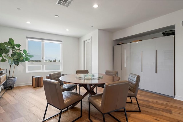 dining area with light hardwood / wood-style floors