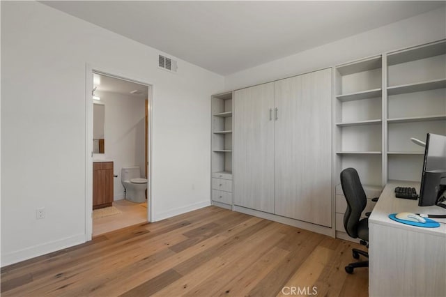 unfurnished office with light hardwood / wood-style flooring